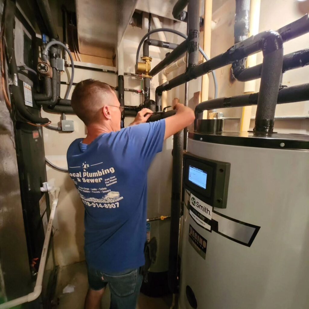 Local Plumbing & Sewer technician installing a water heater in a Loganville, GA garage