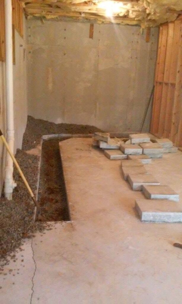 Basement slab cut open for an under-floor sewer line repair at a Loganville, GA home