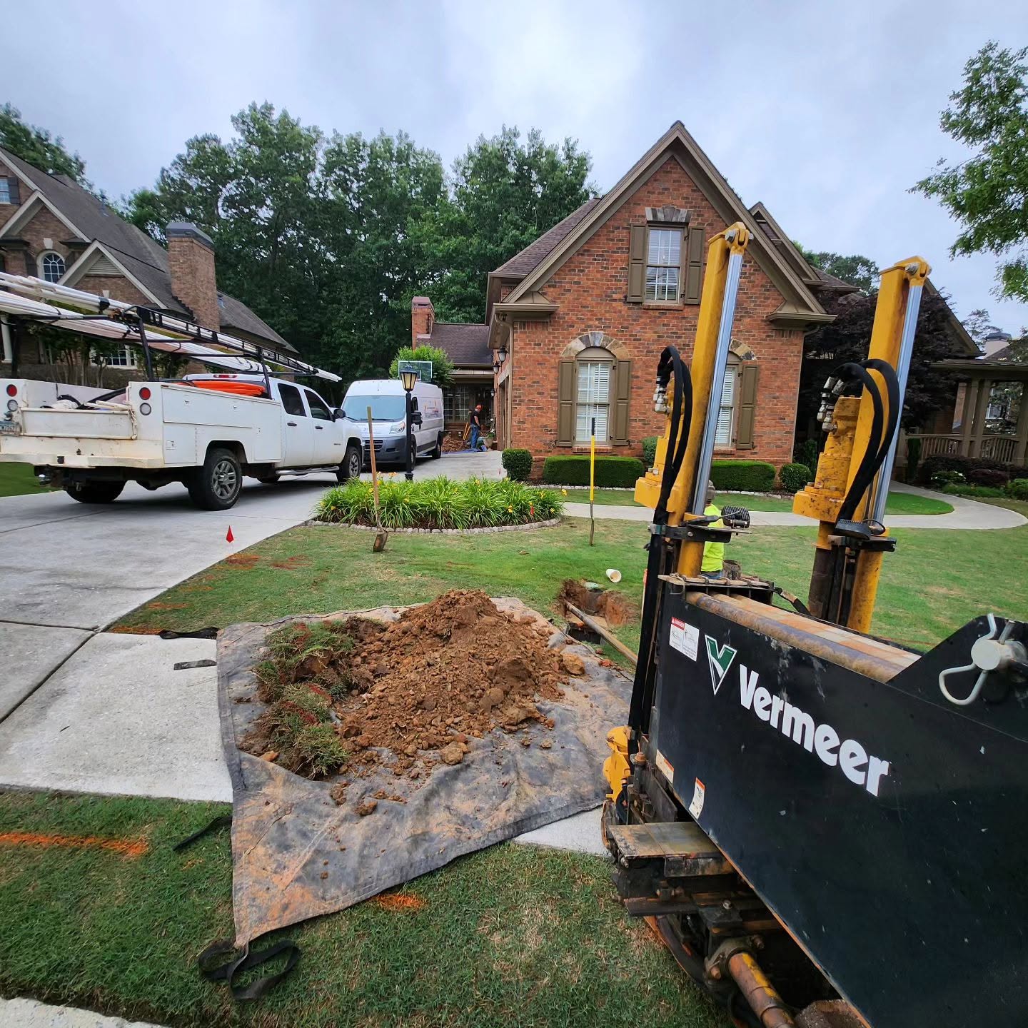 Trenchless boring rig set up in a front yard for an underground pipe job